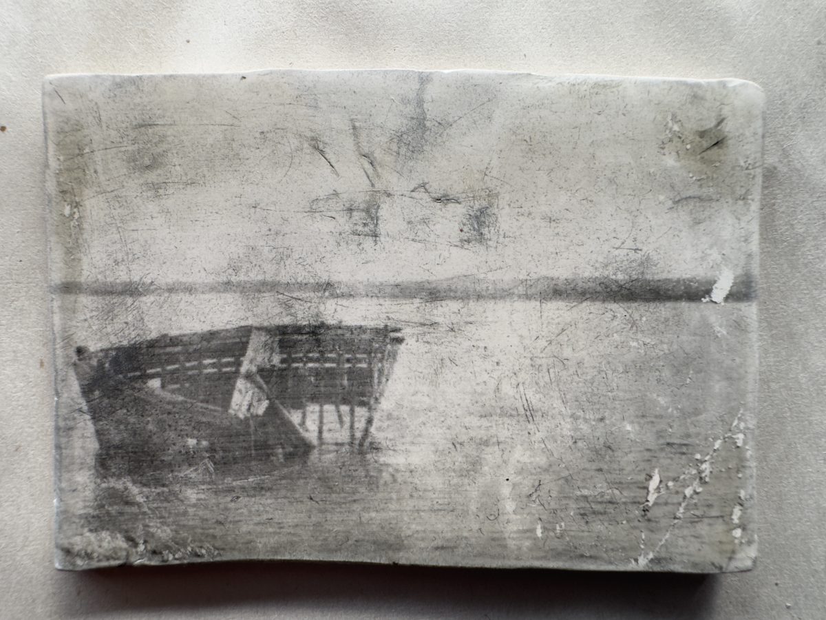 a faded image of a boat wreck in shallow waters